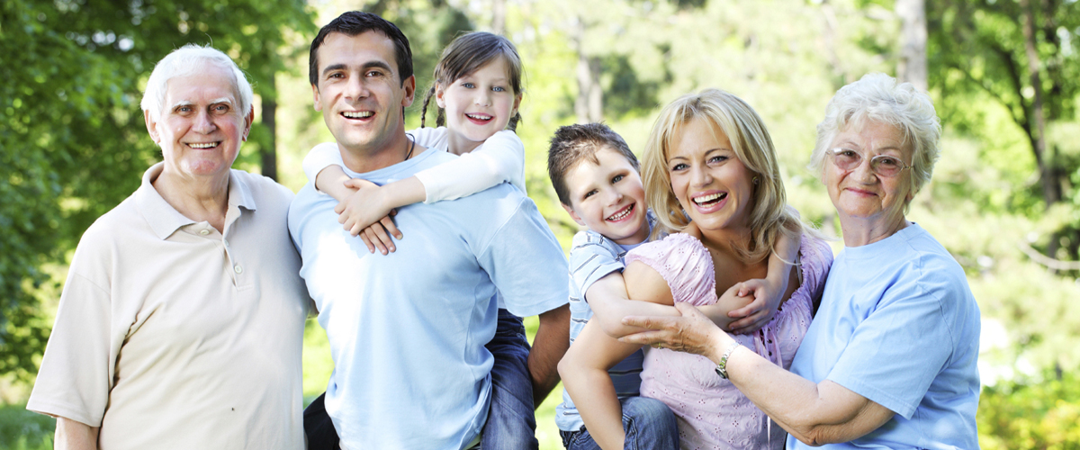 Extended happy family standing in the park.